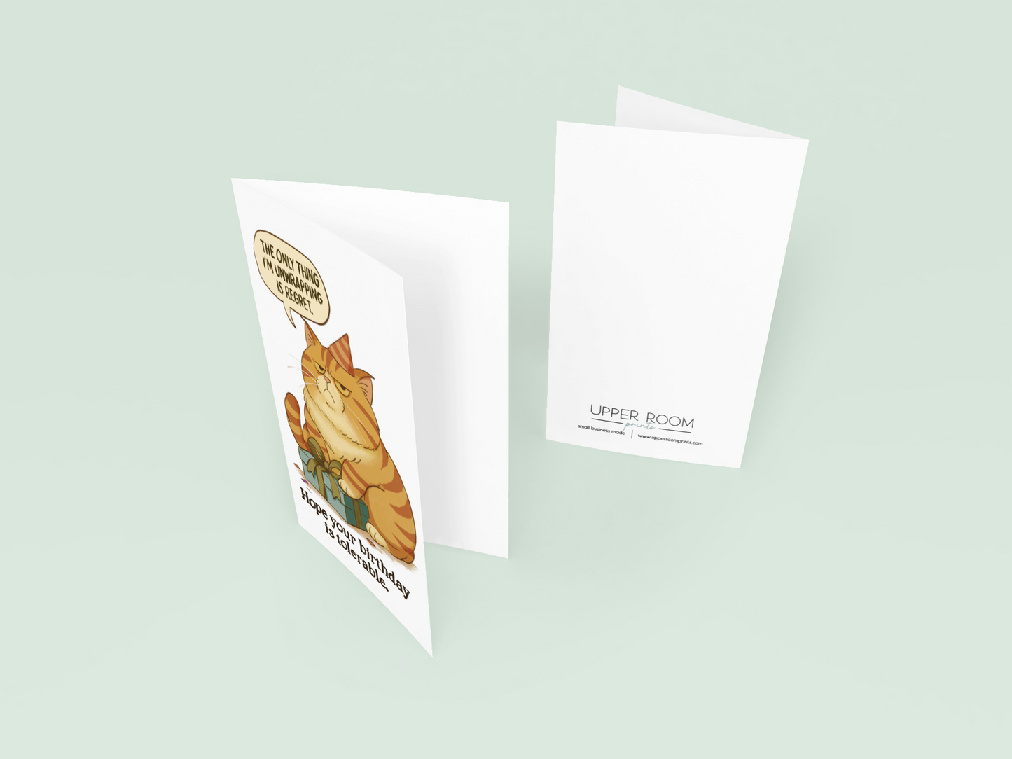A slightly opened birthday card with a grumpy illustrated cat on the front, styled for humor and pet lovers.