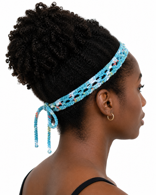 Woman wearing a blue beaded headband with a white background