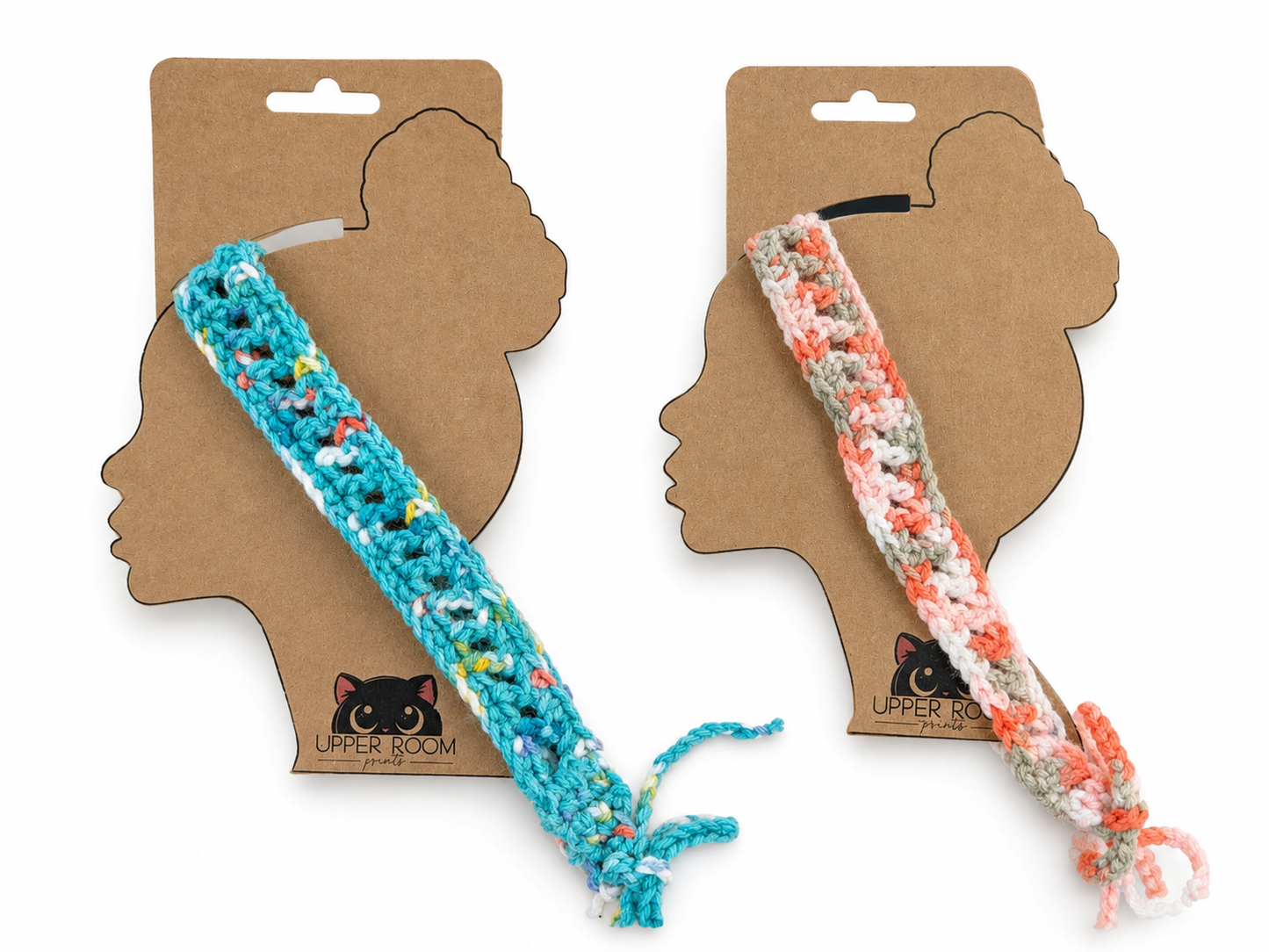 Two headbands, one blue and one multicolor, on cardboard packaging with a silhouette of a head.