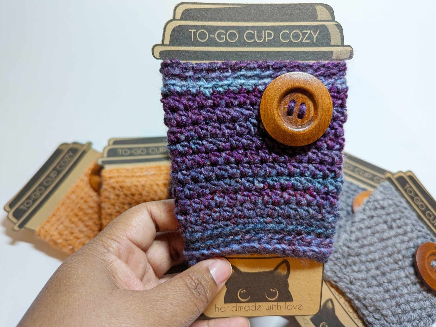 Purple Cozy Sweater Drink Cozy made from acrylic yarn displayed standing alone.