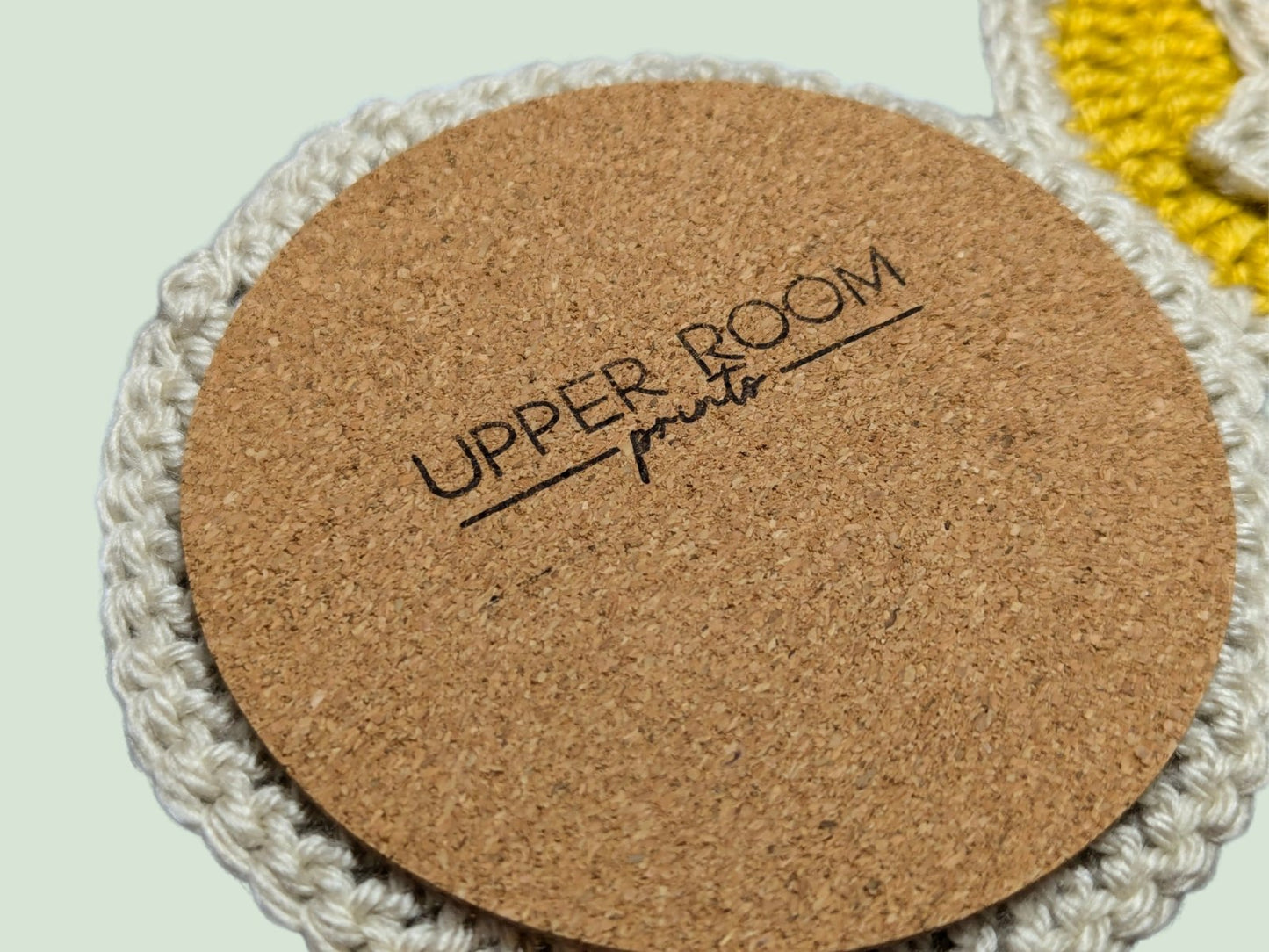 Back view of Crochet Nook Coin Coaster showing cork base for surface protection and grip.