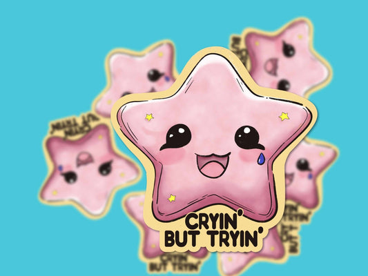 Close-up of the Cryin' but Tryin' Sticker, featuring a hand-drawn pink star on durable weatherproof vinyl