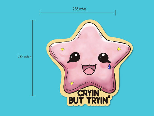 Cryin' but Tryin' Sticker displayed with a size measurement, showing its 2-inch dimensions for easy placement.