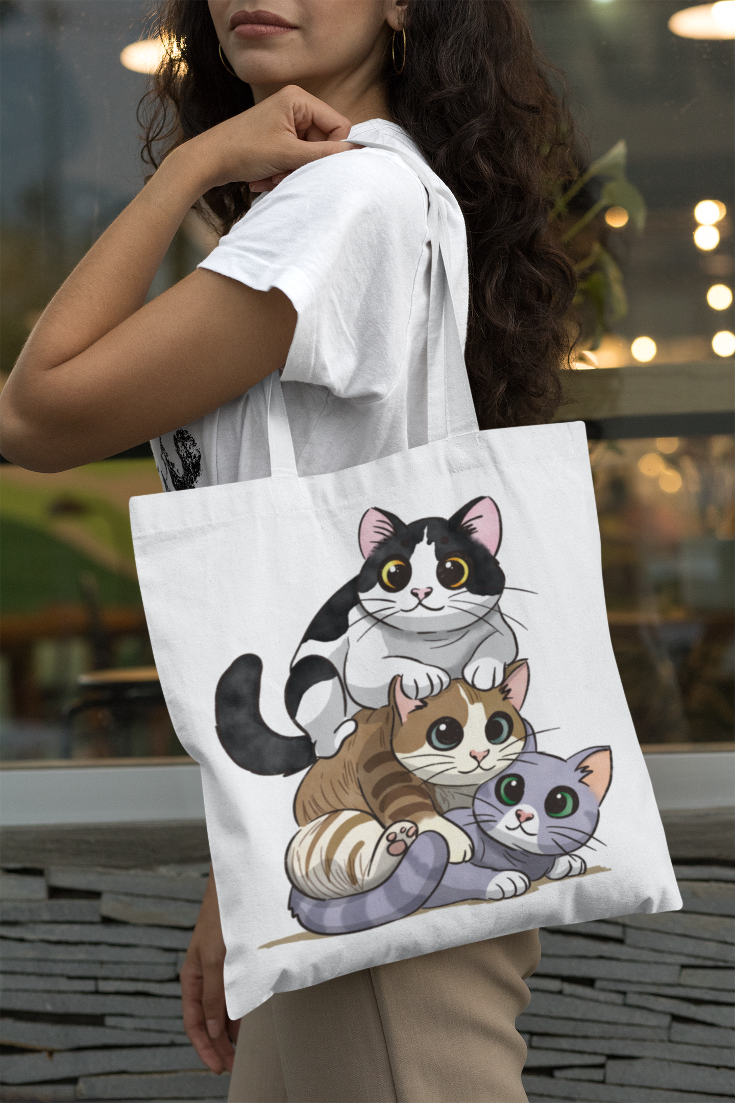 Woman wearing Kitty Stack tote bag on shoulder, 16x15 cotton reusable bag perfect for cat lovers and shopping