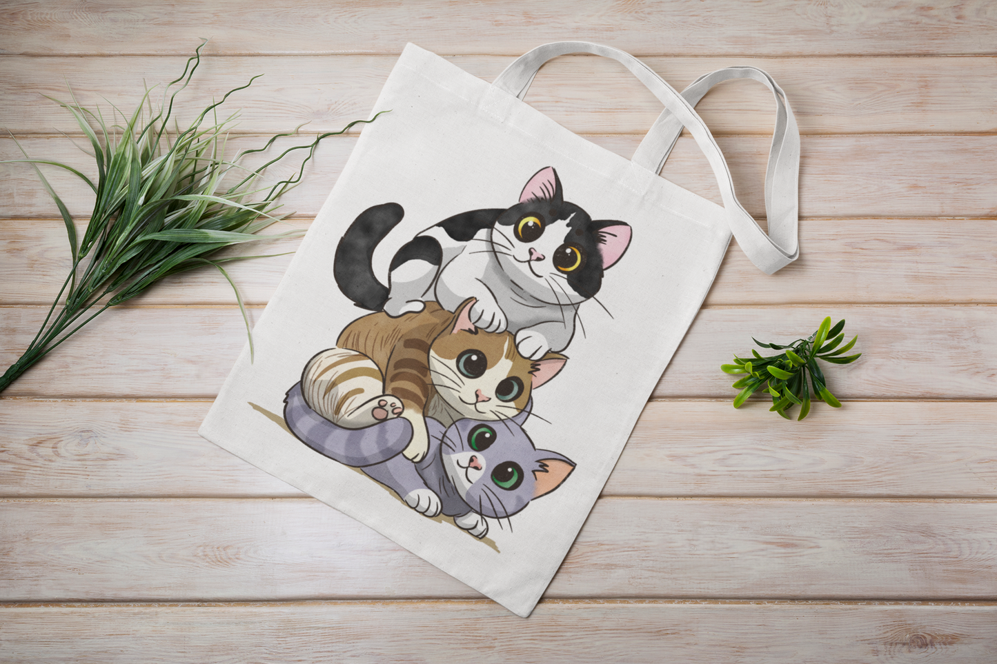 Kitty Stack cotton tote bag on wooden background showing hand-drawn cat design, eco-friendly reusable bag