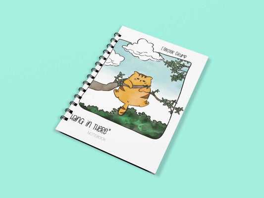 Front view of the Mr. Grump Hang In There Notebook showing the hand-drawn grumpy cat hanging from a tree on the 4x6 spiral cover.