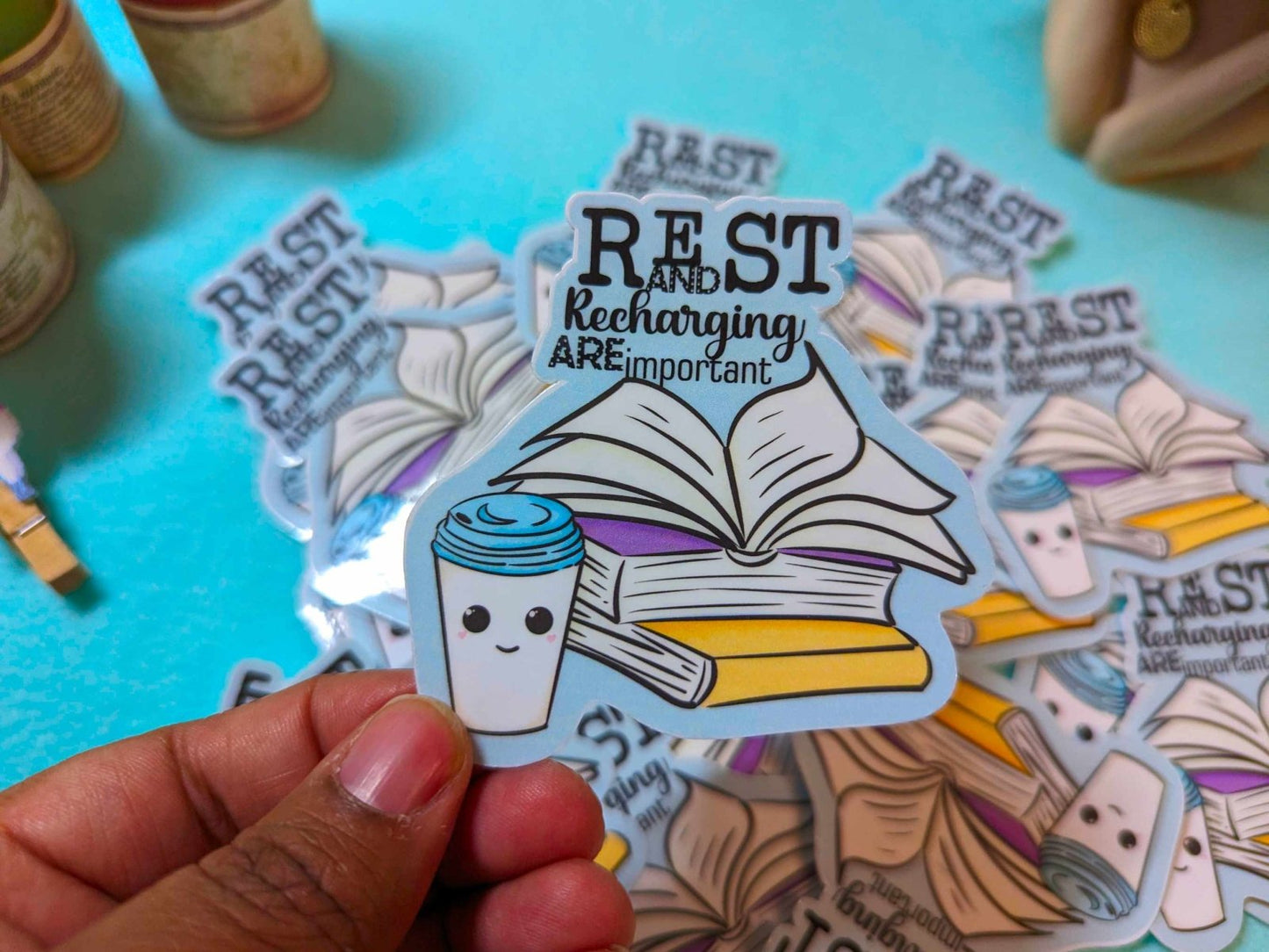Rest and Recharging Are Important Sticker held in hand, featuring a self-care reminder design on waterproof vinyl material.
