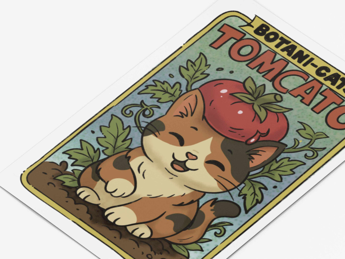 Close-up of Tomcato art print showing calico cat with tomato hat and leafy vines, part of the Botani-Cats and Chaos Kitties collection