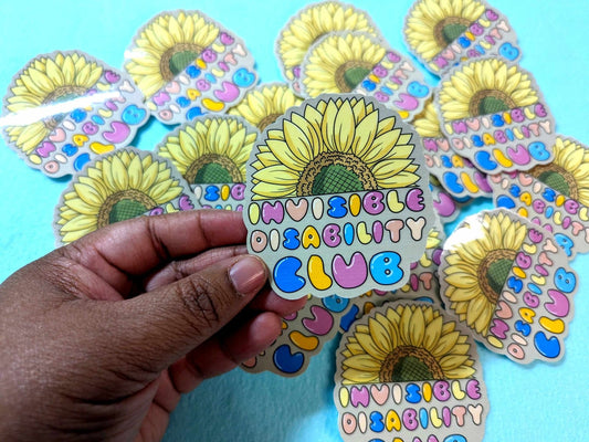 Invisible Disability Club Sticker held in hand, showcasing its vibrant sunflower design and waterproof vinyl material for everyday use.
