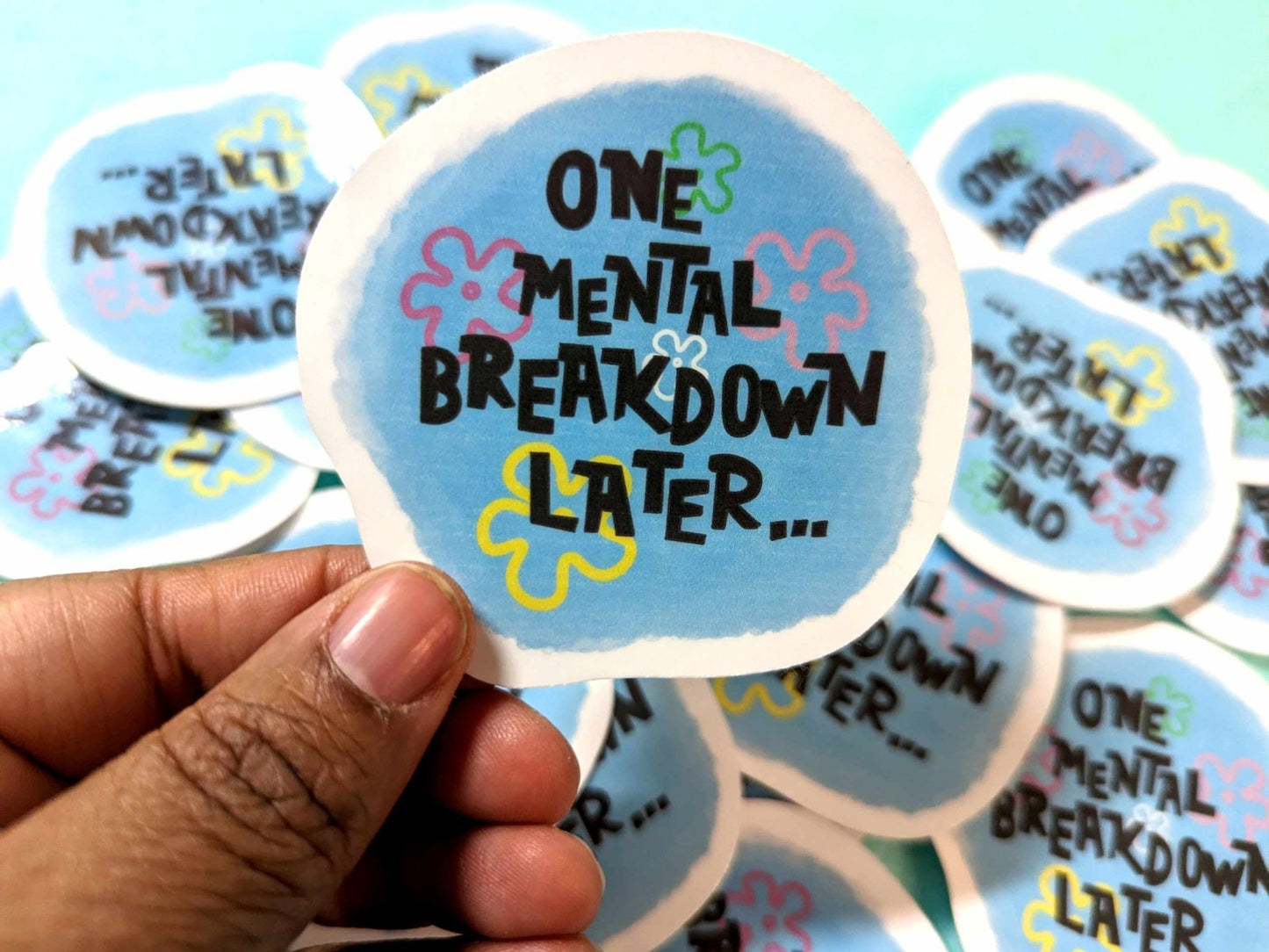 One Mental Breakdown Sticker held in hand, featuring a bold humorous design on waterproof vinyl material.