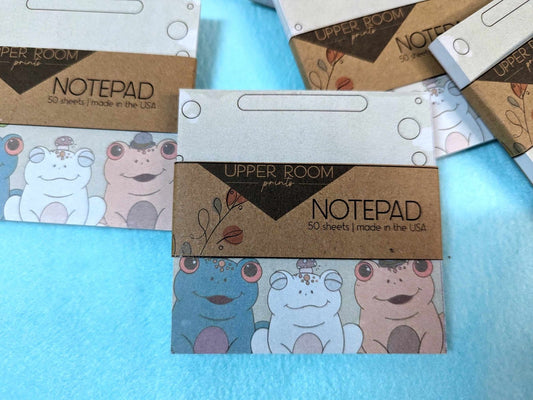 Stack of Trio Frog Notepads showing 3x3 handmade memo pads with hand-drawn frog designs