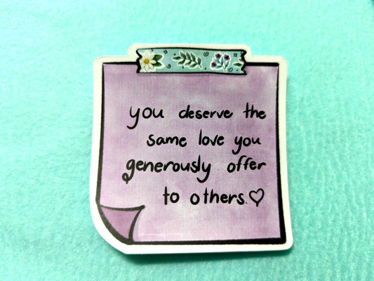 Close-up of the You Deserve Sticker, showcasing its uplifting design and high-quality waterproof vinyl finish