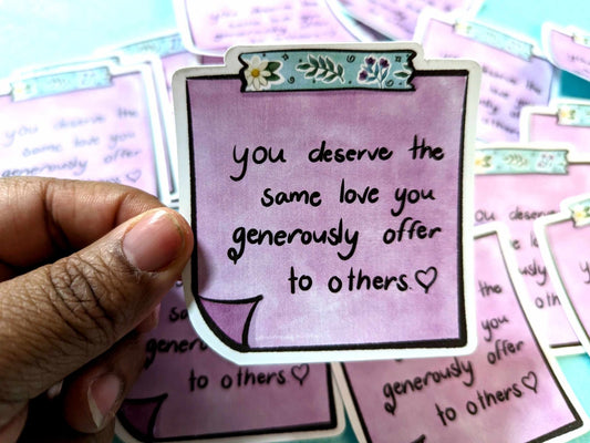 You Deserve Sticker held in hand, featuring a motivational message and a lavender design on waterproof vinyl material