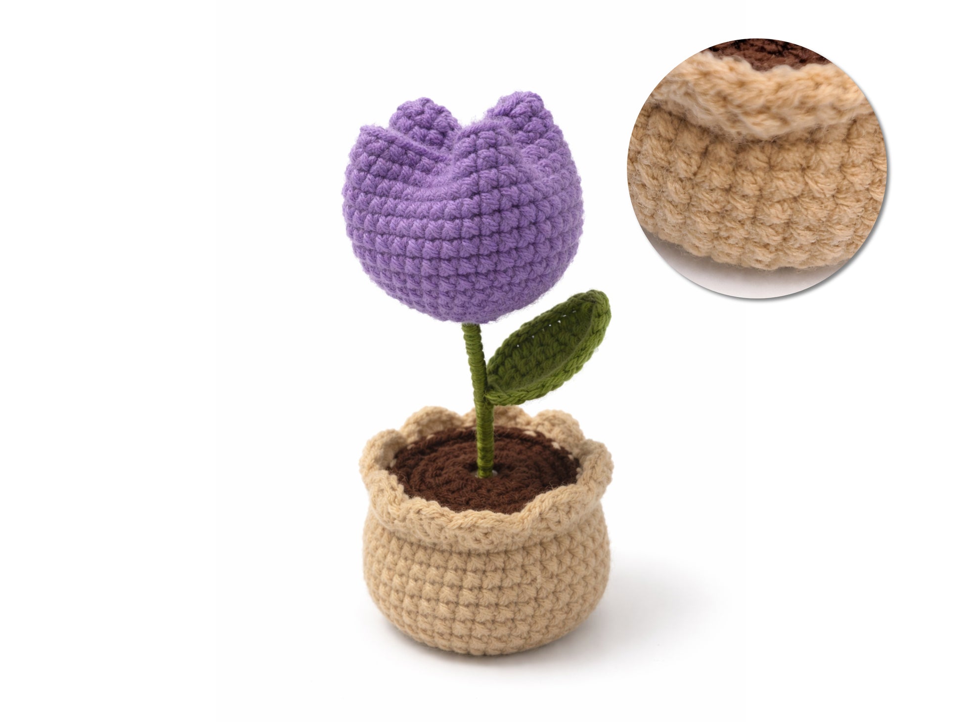 Crocheted purple tulip in a beige pot with close-up of pot texture on a white background