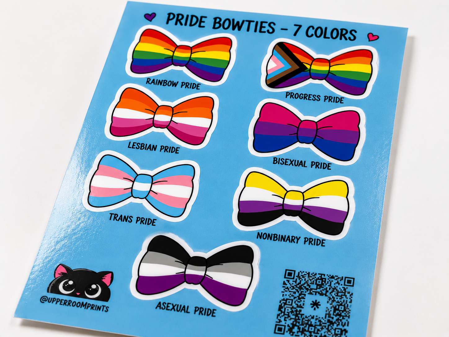 Sticker sheet with pride-themed bowties on a blue background