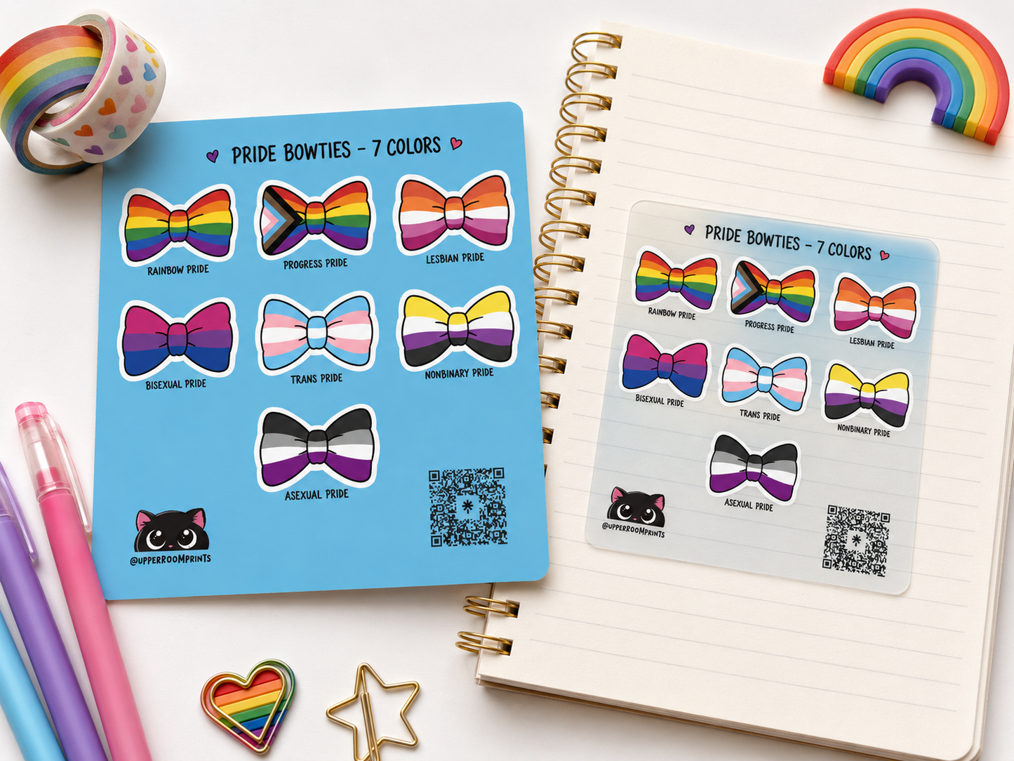Pride bowtie stickers on a notebook with rainbow accents