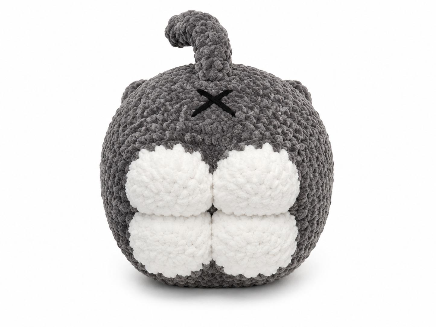 Gray and white knitted toy with a round body and small horns on a white background