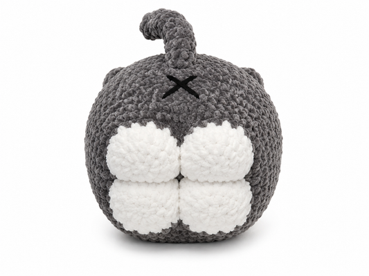 Gray and white knitted toy with a round body and small horns on a white background