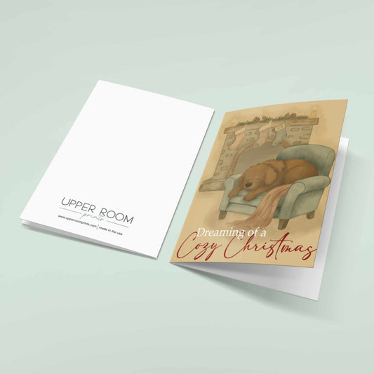 Front and back view of Dreaming of a Cozy Christmas card showing sleeping dog by fireplace scene and Upper Room Prints branding on reverse side