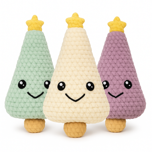Three handmade crochet Christmas tree plushies in sage green, white, and lilac with yellow star toppers and sweet smiling faces
