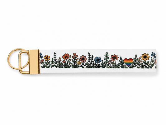 Keychain with floral design and rainbow heart on a white background