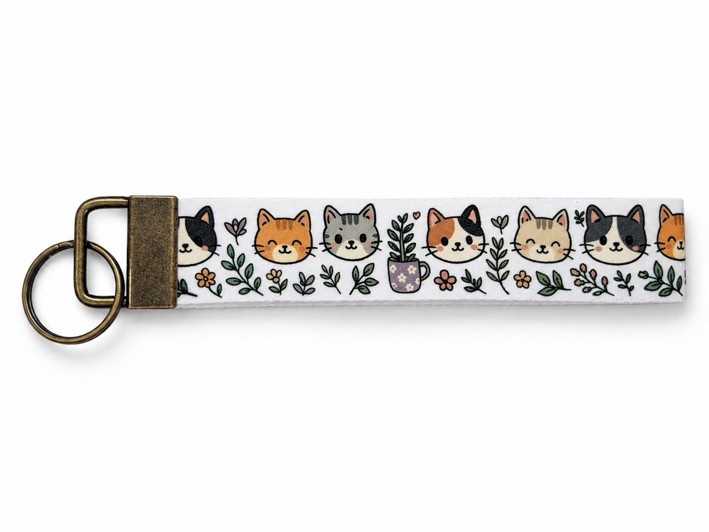 Keychain with cat faces and plants design on a white background