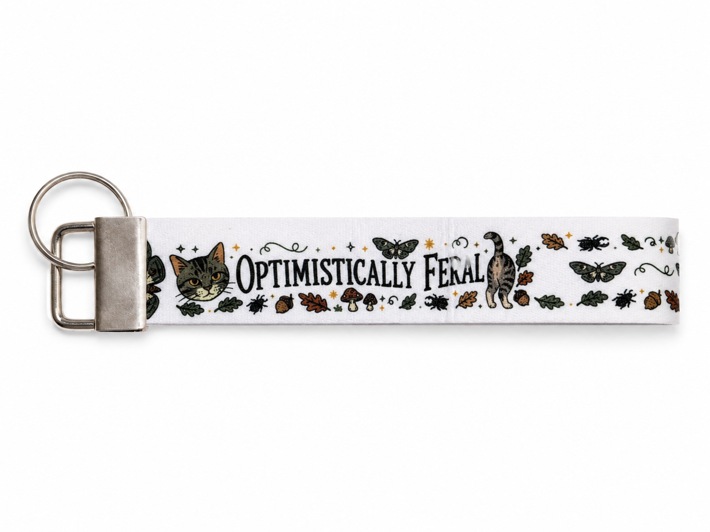 Keychain with 'Optimistically Feral' text and cat illustrations on a white background
