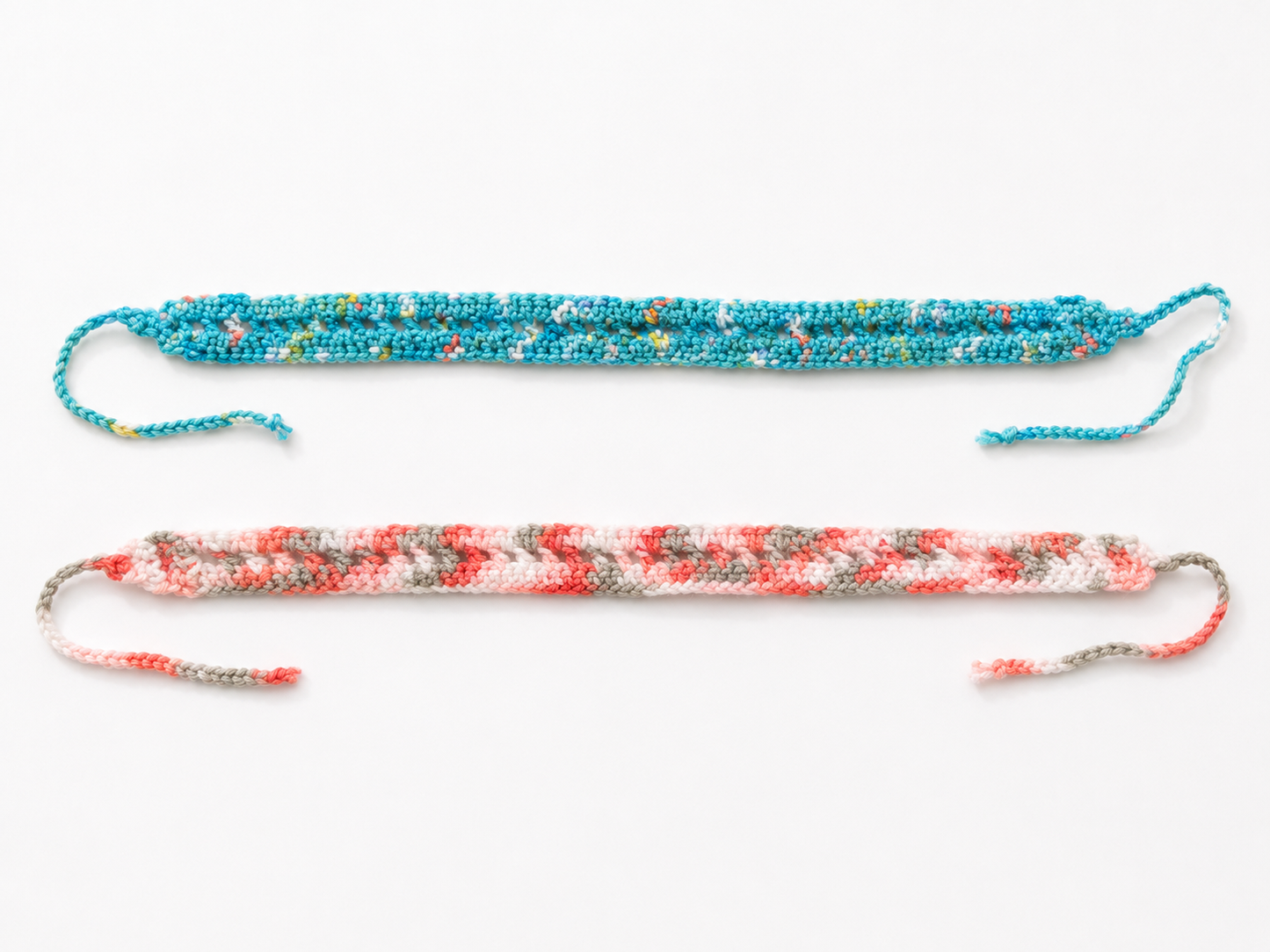 Two colorful braided bracelets on a white background