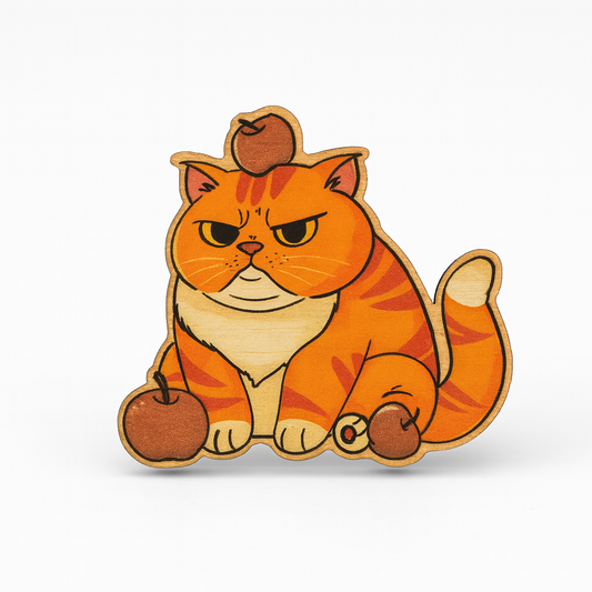 Wooden cat figurine with a brown hat and apples on a white background