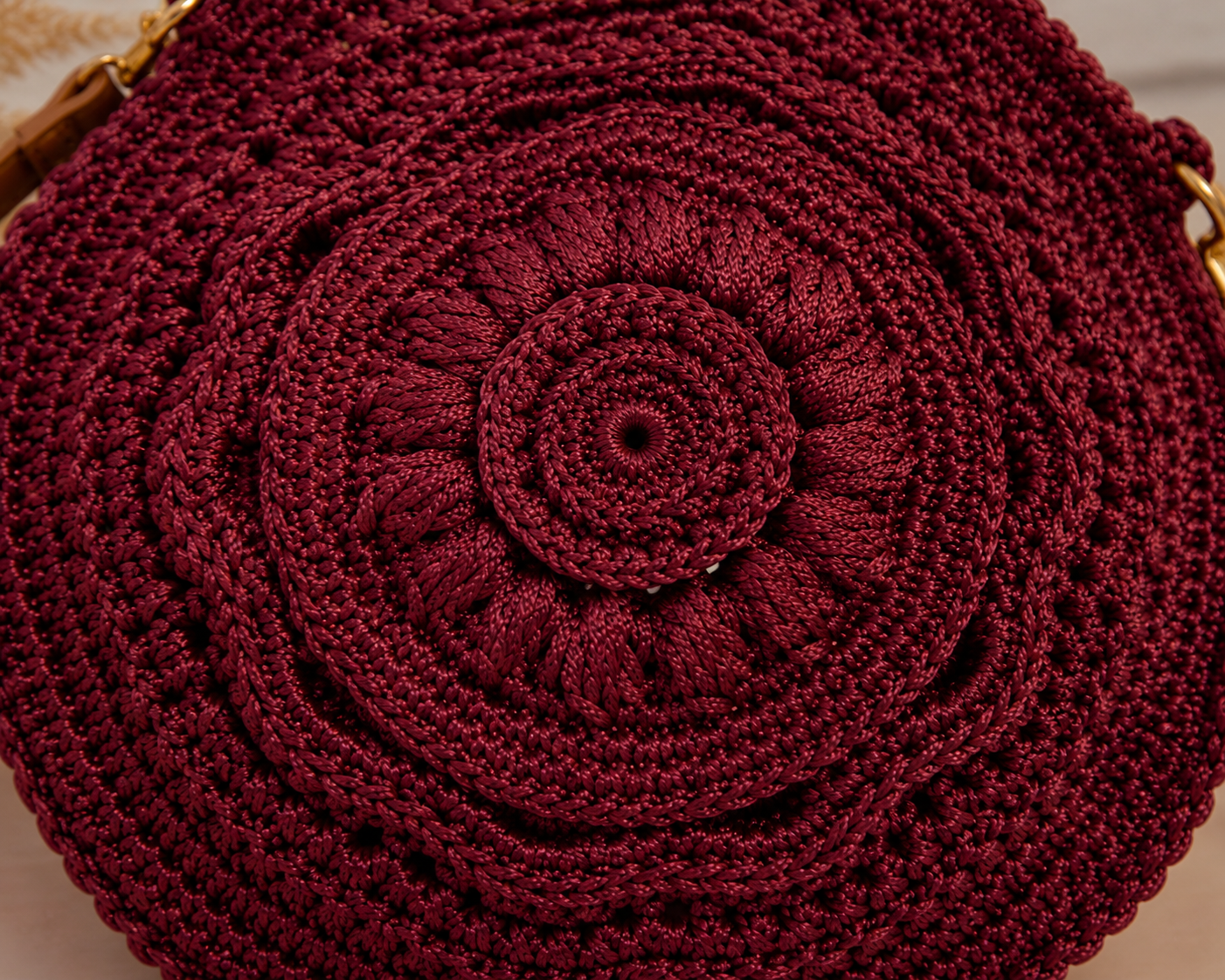 Close-up of a red crochet bag with a circular pattern.