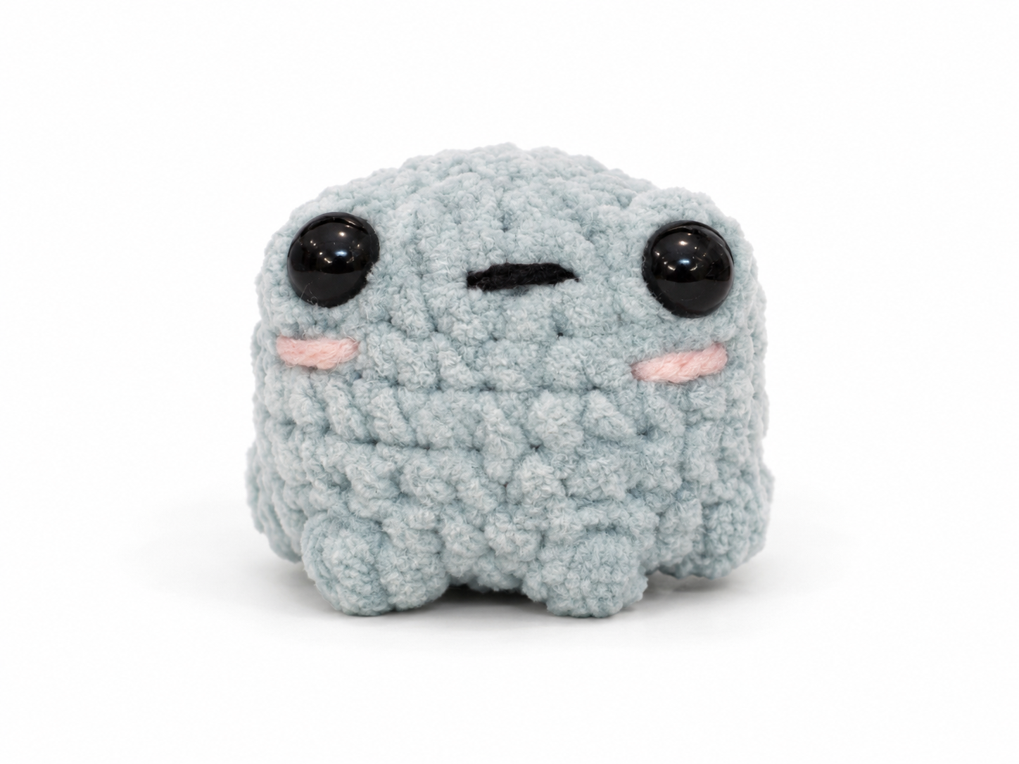 Plush toy with a sad expression on a white background