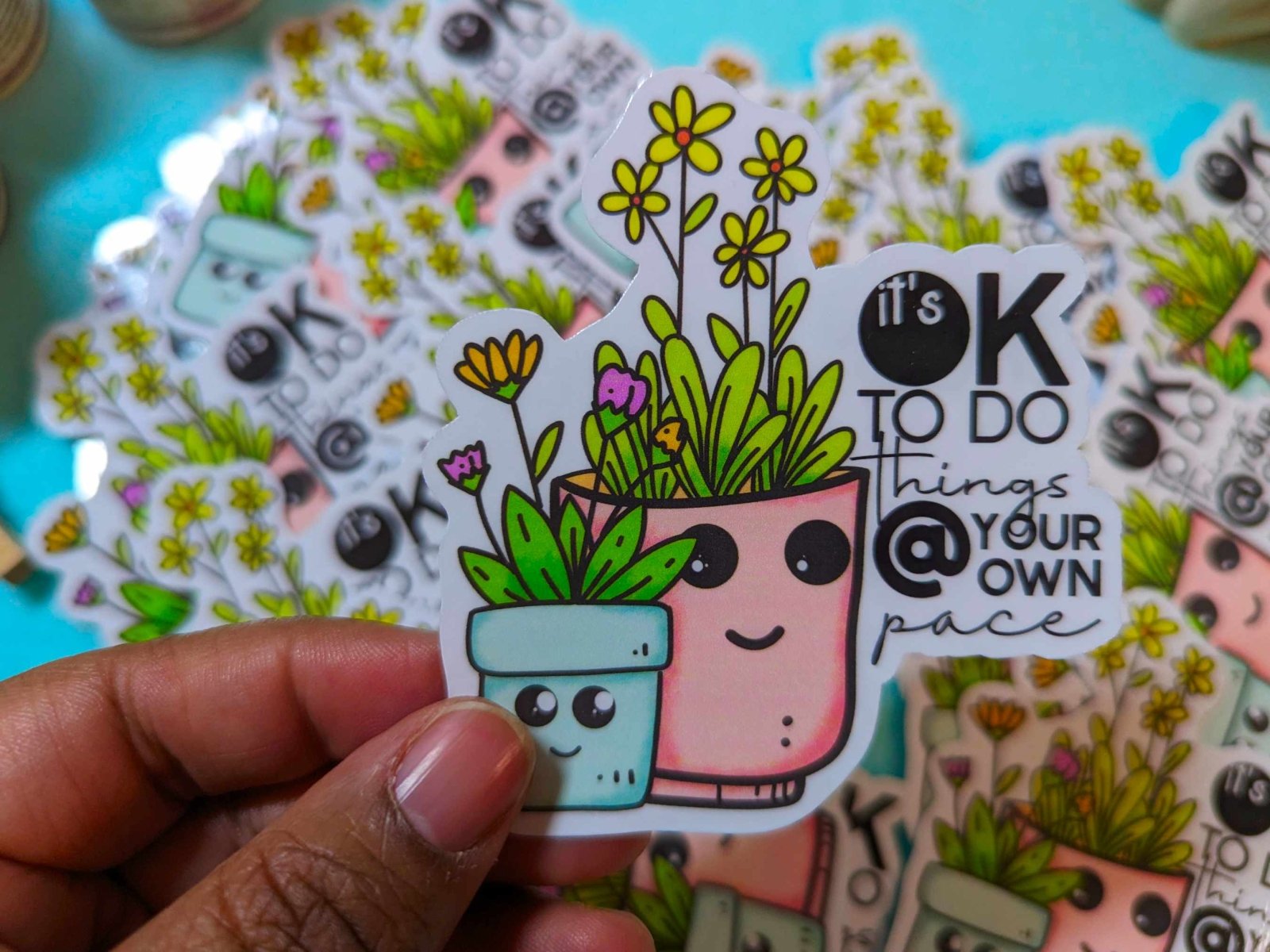 At Your Own Pace Sticker held in fingers, showcasing its waterproof vinyl design and 3-inch size for laptops, bottles, and planners