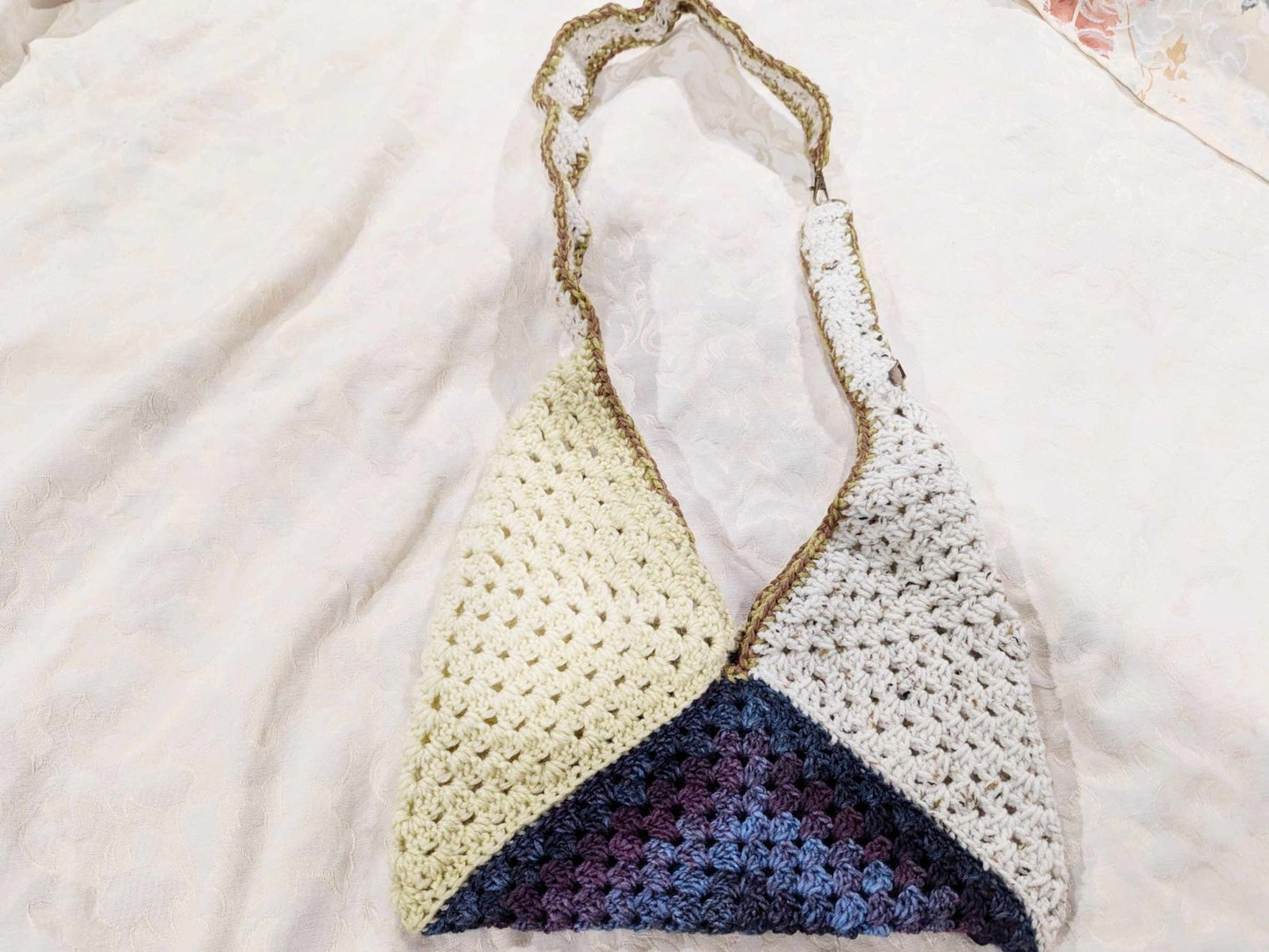 Handmade crochet Boho Granny Purse in blue tones. A lightweight crossbody bag with a reinforced strap and lobster clasp, perfect for bohemian and cottagecore fashion.