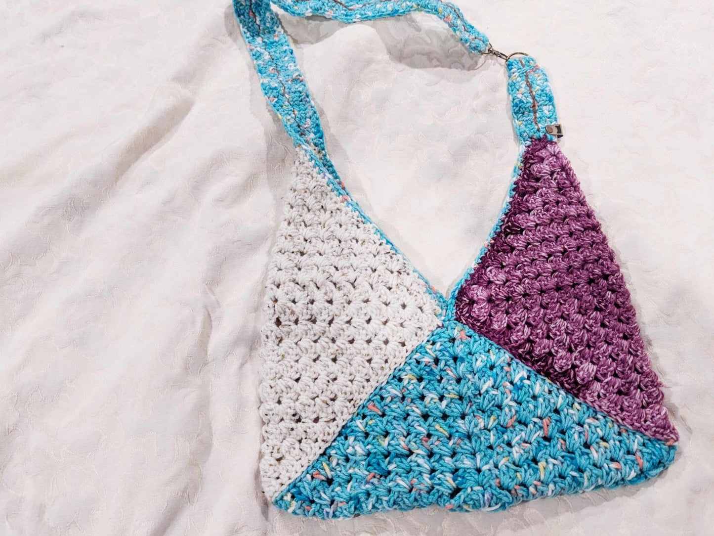 Custom crochet Boho Granny Purse in purple hues. A stylish and lightweight handmade crossbody bag with a secure strap, ideal for everyday use and gifting.