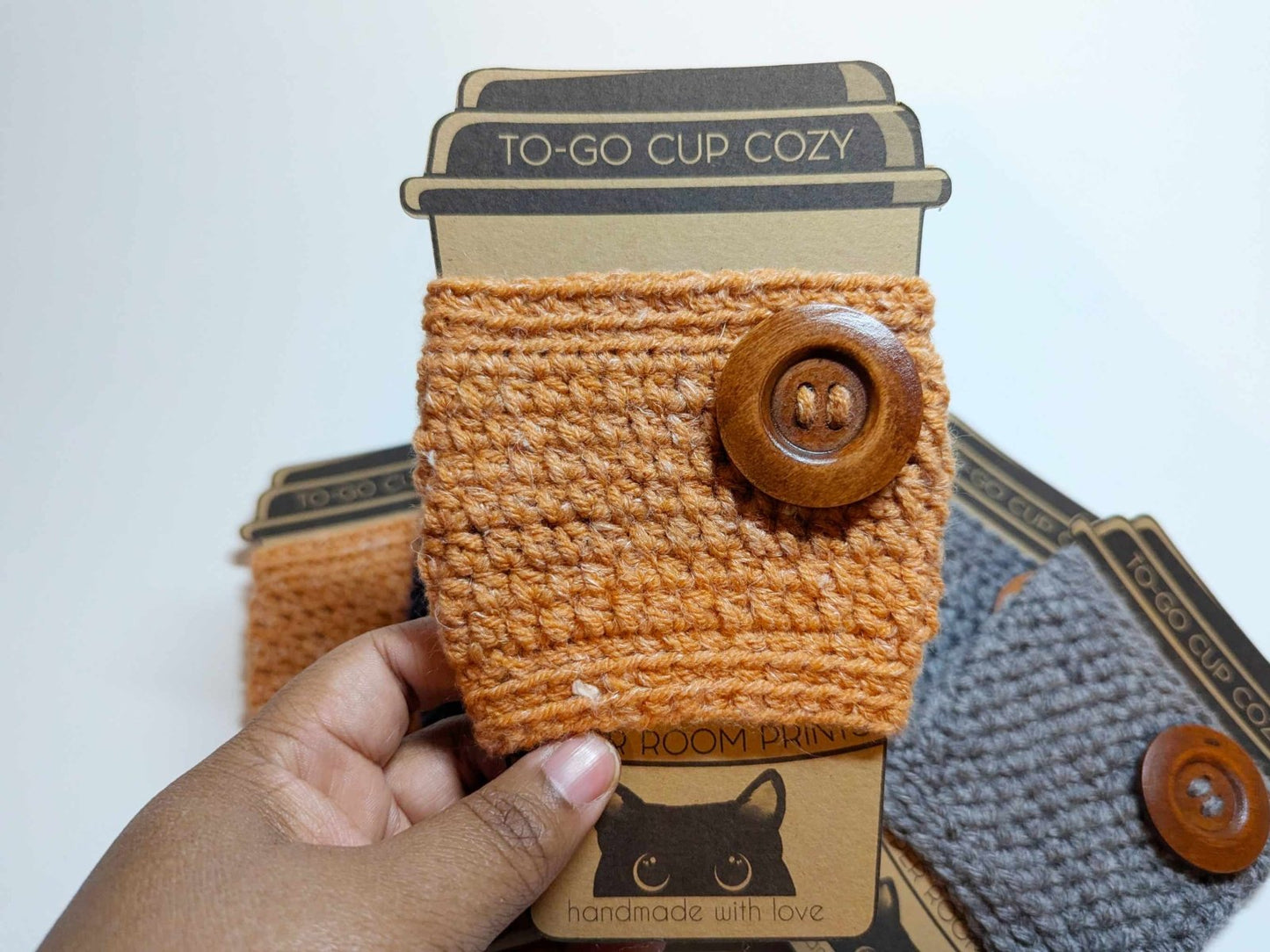 Orange Cozy Sweater Drink Cozy shown on its own as a fall-themed handmade cup sleeve.