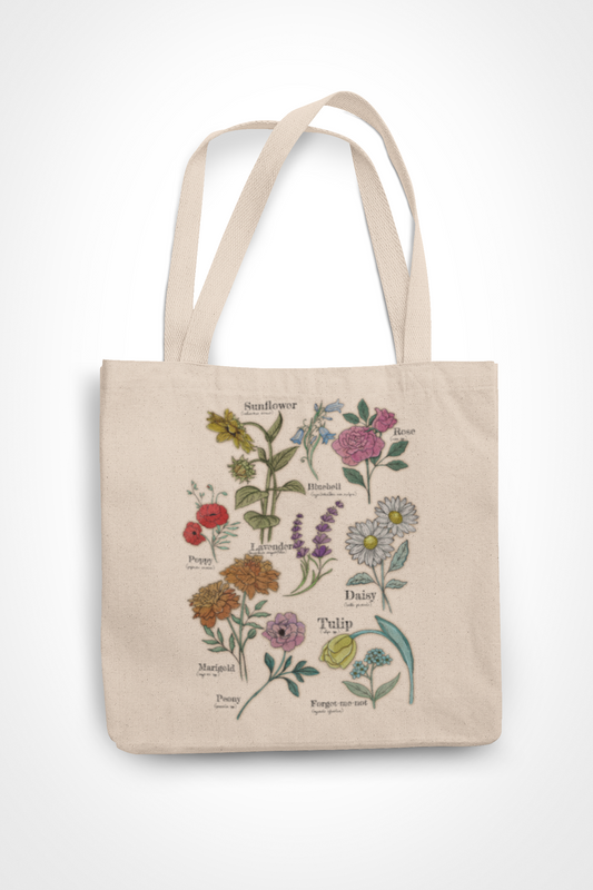Natural canvas tote bag featuring colorful botanical illustration of labeled wildflowers including sunflower, rose, daisy, poppy, lavender, and tulip