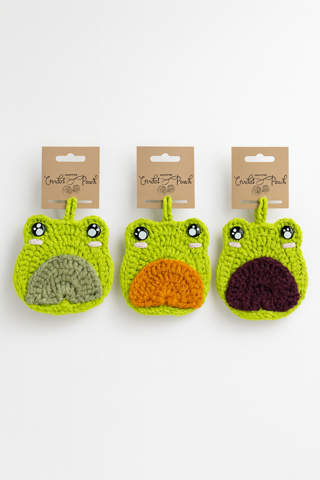Handmade crochet frog bag charms showing all three tummy color options: green, purple, and orange