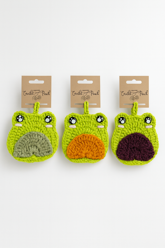 Handmade crochet frog bag charms showing all three tummy color options: green, purple, and orange