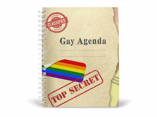 Front cover of Gay Agenda notebook with rainbow pride flag, classified stamp, and top secret label on spiral-bound design