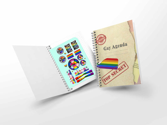 Gay Agenda notebook shown open with included LGBTQ+ themed sticker sheet and matching pride cover design