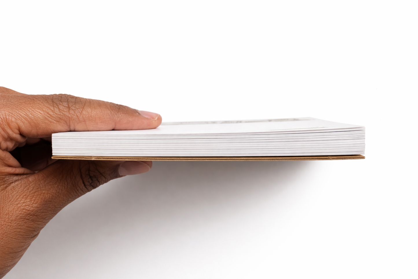 Hand holding a stack of white papers on a white background