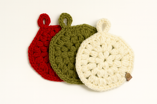 Handmade crochet Christmas hexagon coasters in red, green, and ivory yarn, 3-pack set for holiday table