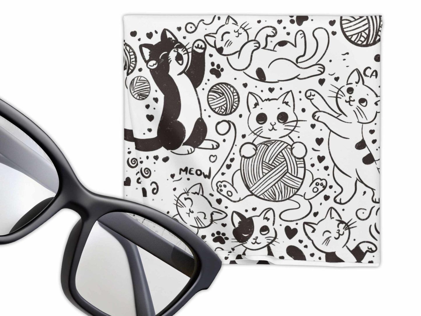 Doodle art of playful black-and-white cats with yarn balls and hearts on microfiber cleaning cloth