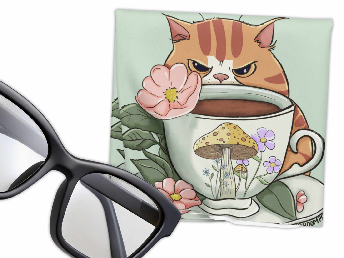Grumpy orange cat sitting in a teacup with mushroom and floral illustrations on microfiber cloth