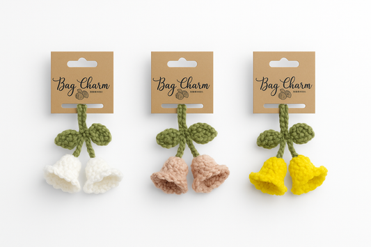 Handmade crochet lily of the valley bag charm with white, peach, and yellow flowers, cottagecore keychain accessory