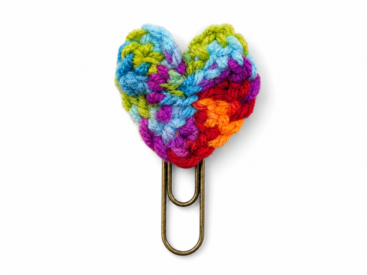 Colorful crocheted heart-shaped clip on a white background
