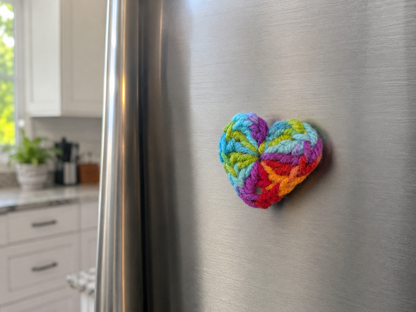 Colorful heart-shaped magnet on a refrigerator in a kitchen setting