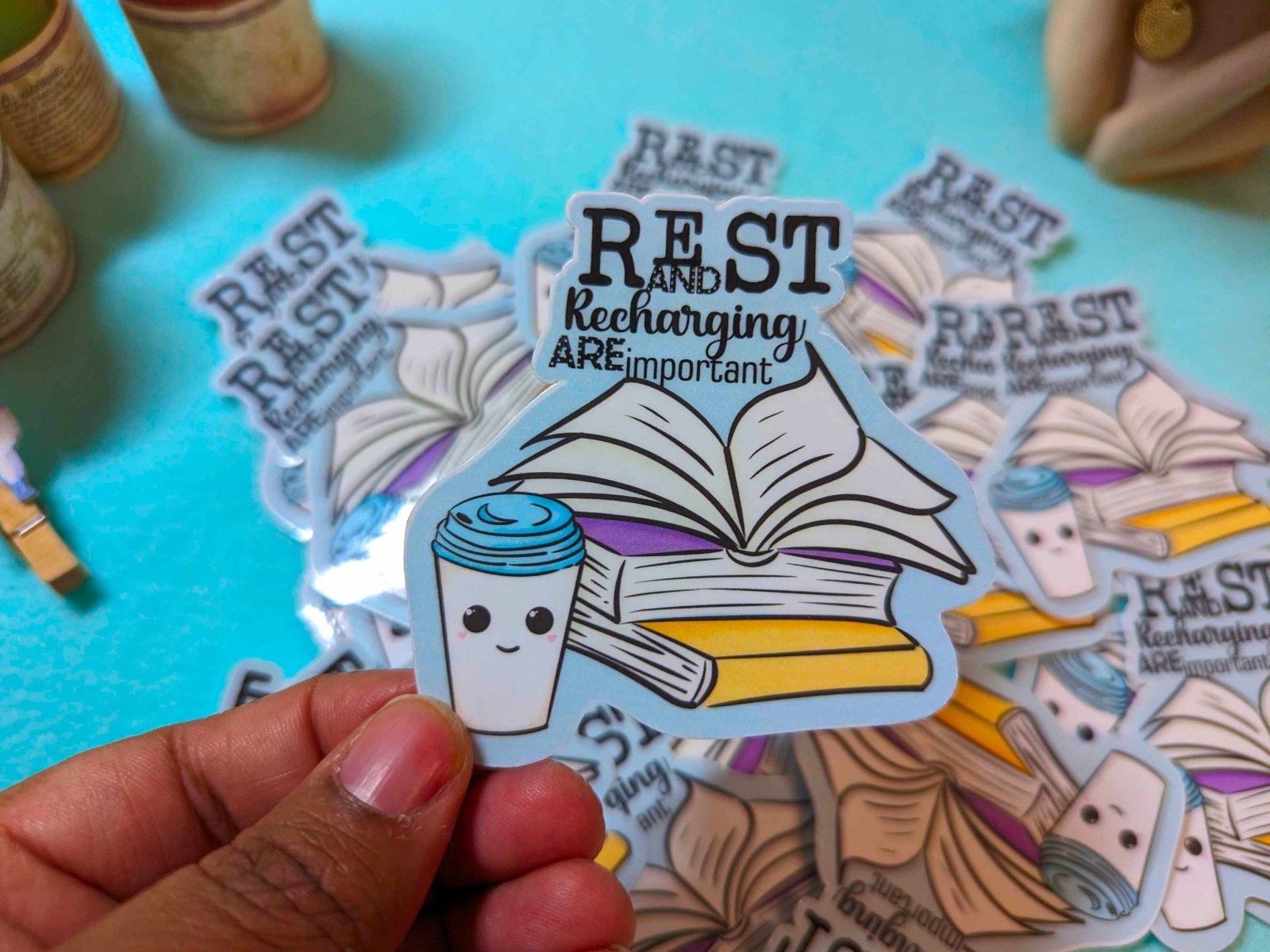 Rest and Recharging Are Important Sticker held in hand, featuring a self-care reminder design on waterproof vinyl material.