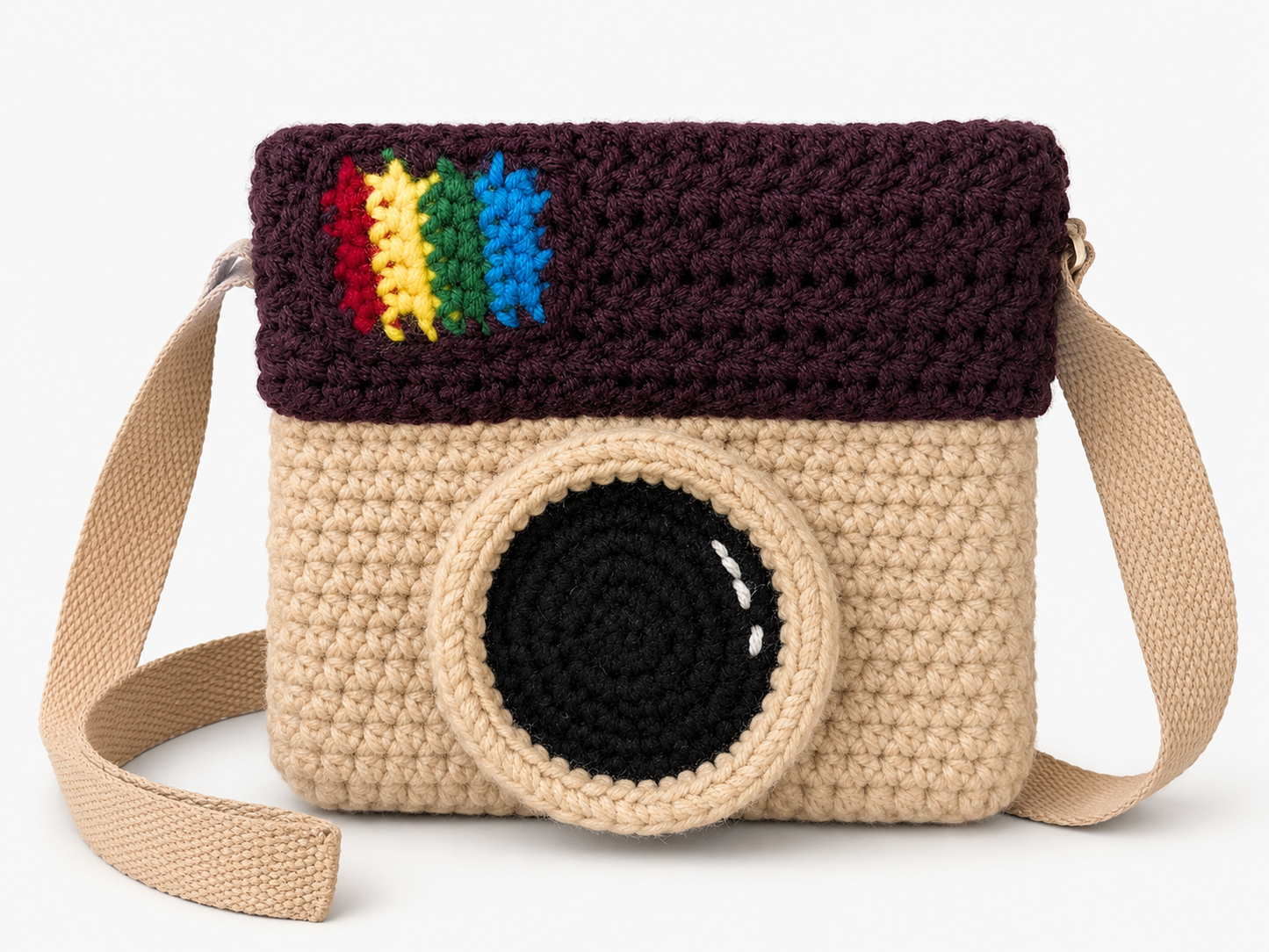 Crocheted camera-shaped bag with rainbow design on a white background